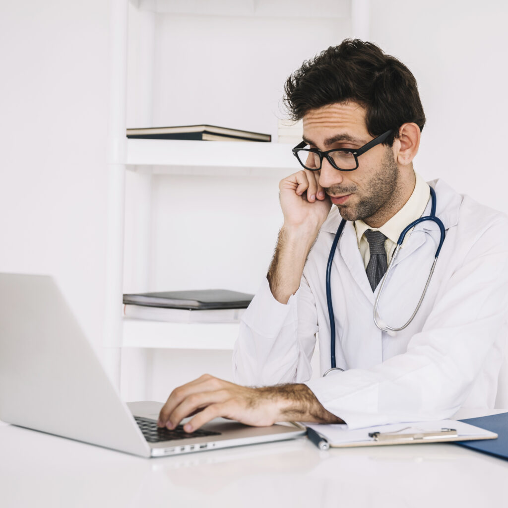 doctor wearing eyeglasses using laptop doctor wearing eyeglasses using laptop